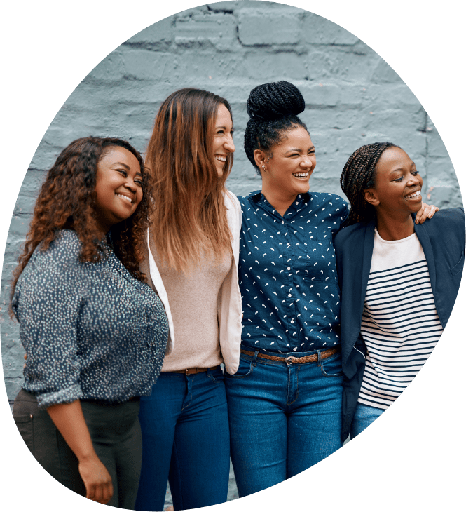 A group of smiling women with their arms around each other
